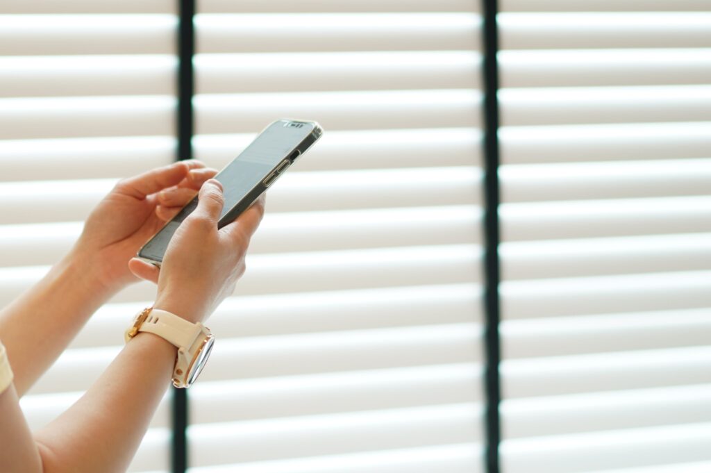 woman-hand-use-smartphone-near-window